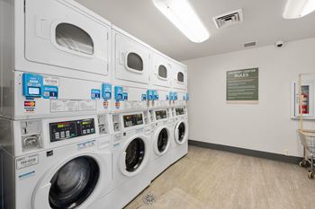 A row of washing machines in a laundromat.